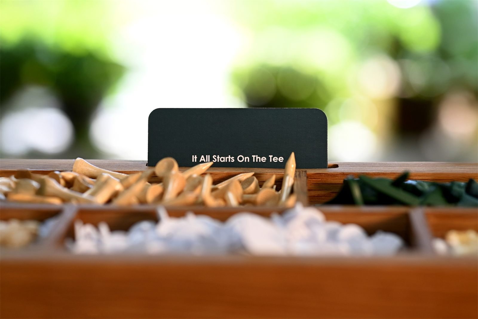 "It All Starts On The Tee" branded product photo
